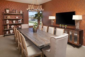 a dining room with a table and chairs and a television